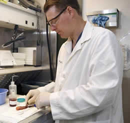 Mark Anderson, PA-C processing a specimen in the gross room.